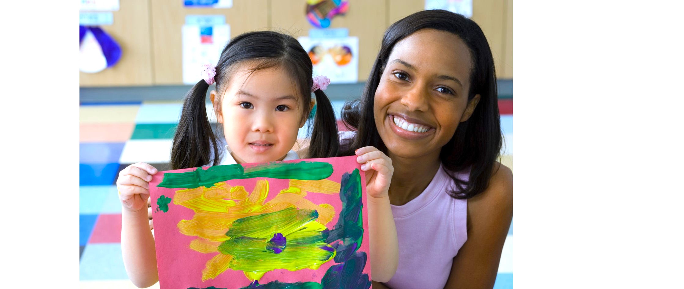 student and teacher take a picture with students painting